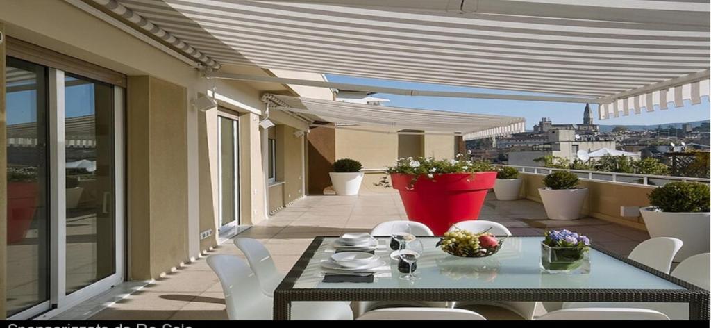 a patio with a table and chairs on a balcony at La Terrazza in Cotronei