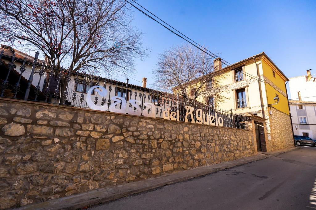una pared de piedra con graffiti al lado de una calle en Casa del Agüelo, en Cella