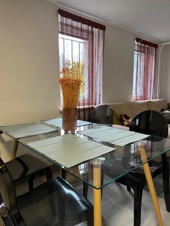 a dining room with a glass table and chairs at Cozy apartment in Ljubljana - Free parking in Ljubljana