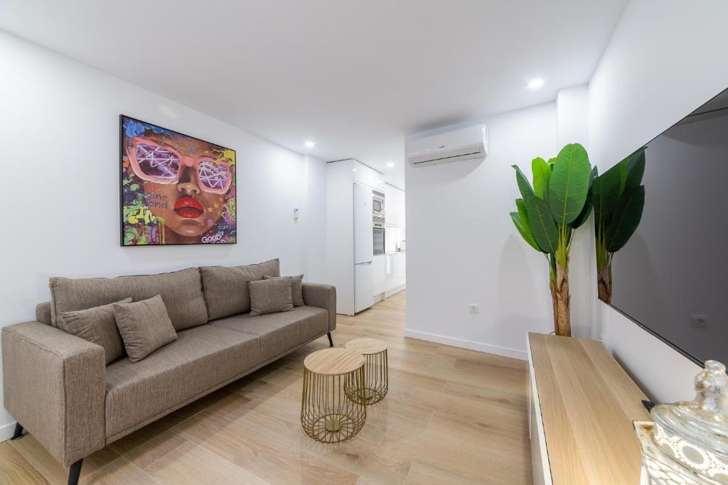 a living room with a couch and a painting on the wall at Trendy Homes Lepanto I in Almería