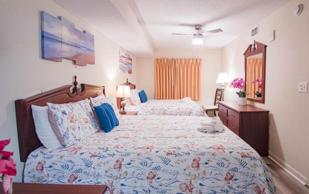 a bedroom with two beds with a cat laying on the bed at Atlantica Resort in Myrtle Beach