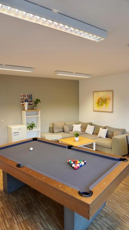 a living room with a pool table and a couch at Apartment Grindelallee Hamburg in Hamburg