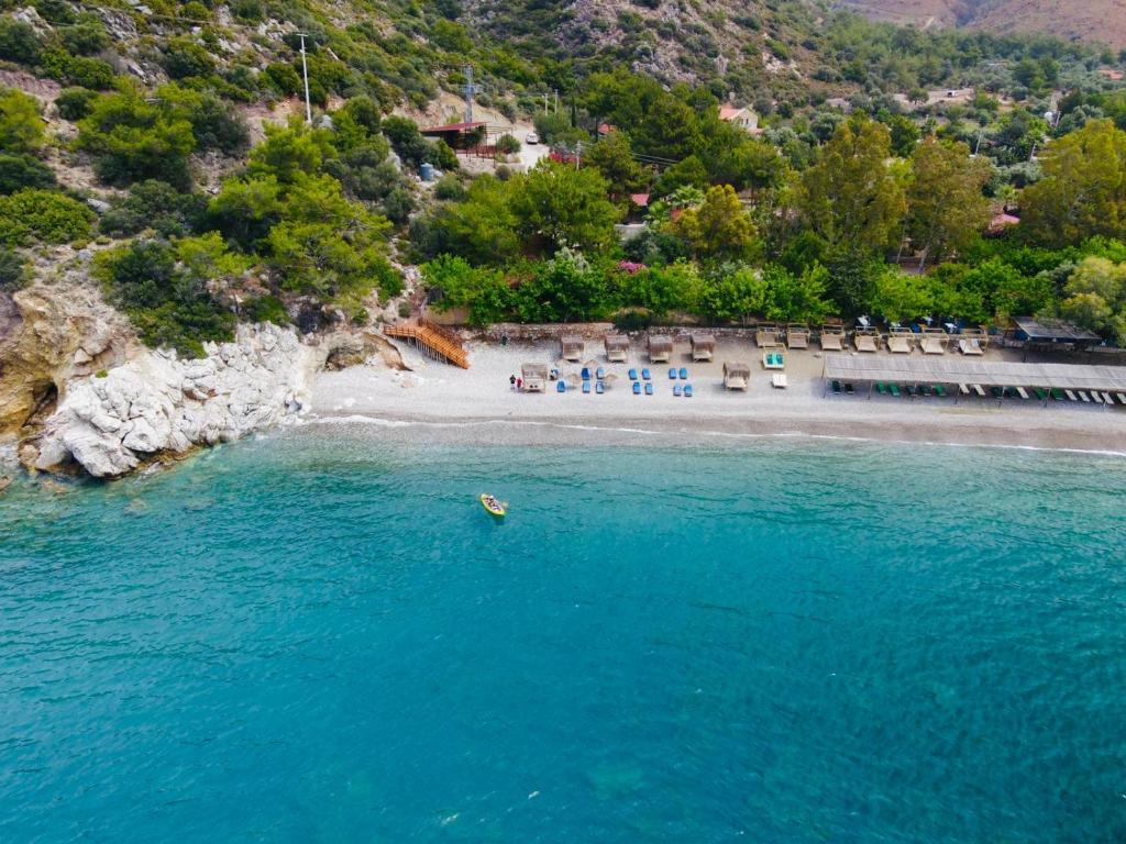 an aerial view of a beach with a group of chairs at Kızılbük Ahşap Evleri in Datca