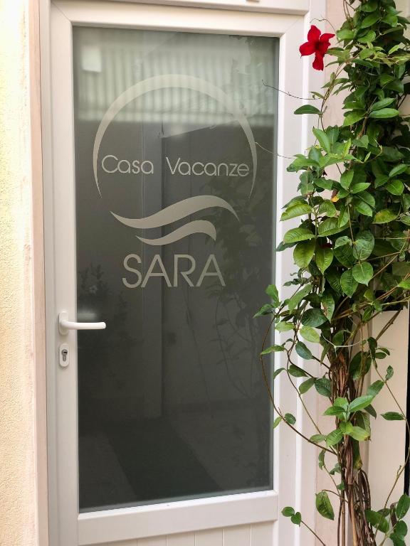 a glass door with a sara sign on it at Casa Sara in Monopoli