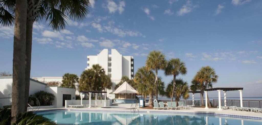 a swimming pool with a hotel in the background at Sandestin Bayfront Studio with balcony and breathtaking views in Destin