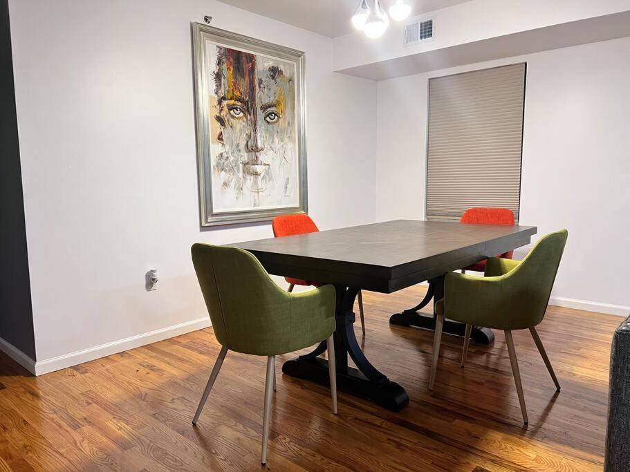 a dining room with a table and four chairs at Urban Oasis 3 Kings bed 3Mins from EWR-NYC Downtow in Newark