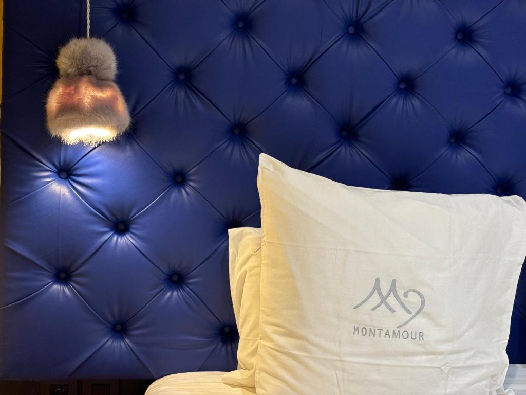 a stuffed animal hanging over a bed with a pillow at Les Secrets - Suites & Apartments in Montriond