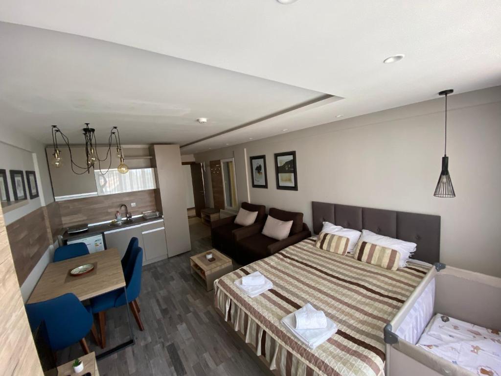 a bedroom with a bed and a couch and a table at Milmari Premier 28 Kopaonik in Kopaonik