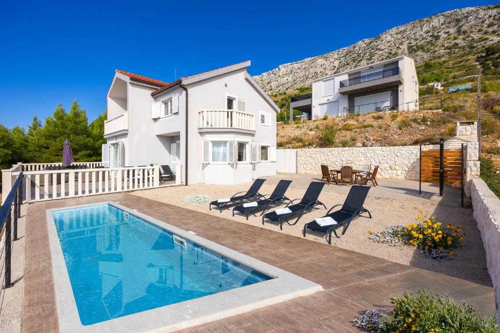 une villa avec une piscine et une maison dans l'établissement Villa Lea with a beautiful view and swimming pool, à Stanići
