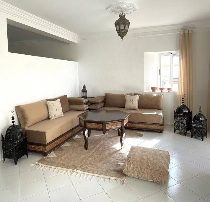 a living room with a couch and a coffee table at Dar Mustapha in Sidi Ifni
