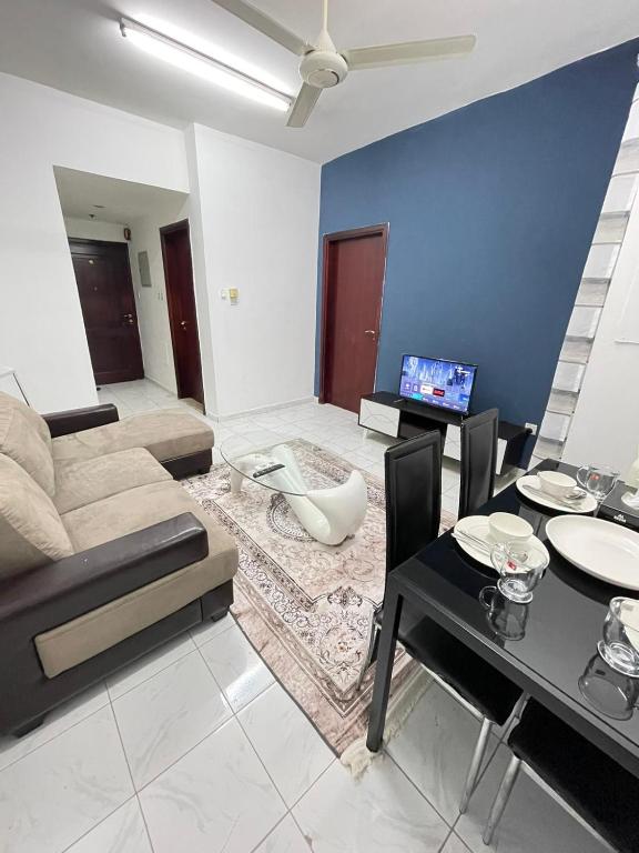 a living room with a couch and a table at 1BHK Sharjah Fully Furnished in Sharjah