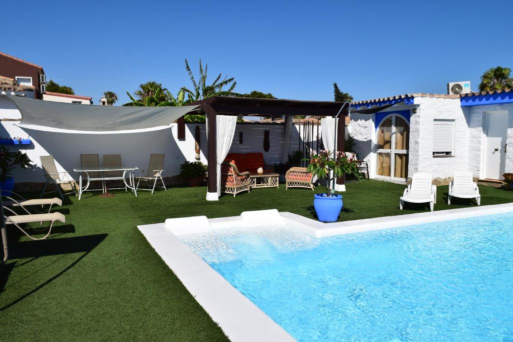 a backyard with a swimming pool and a tent at LOS TOCHOS in Chiclana de la Frontera