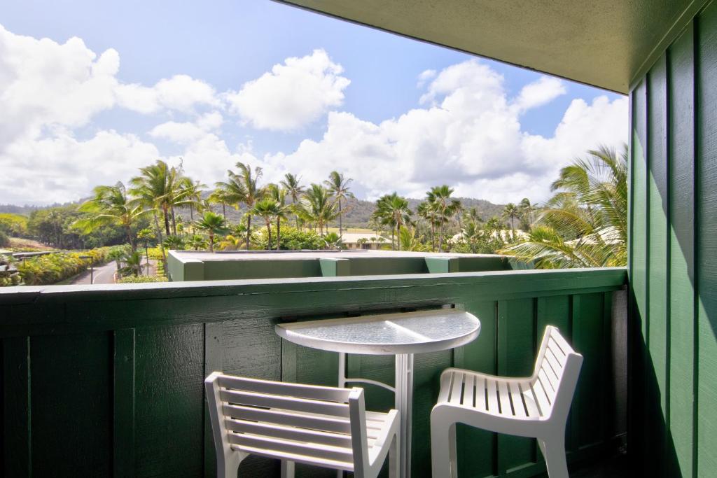 a table and two chairs on a balcony with a view at Kauai Beach Resort Room 2309 in Lihue