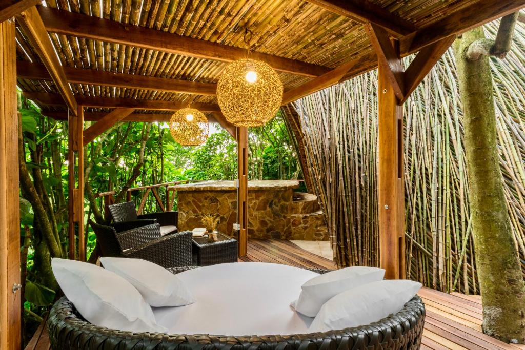 a patio with a white table and chairs on a wooden deck at Hotel Spa La Colina in Pereira