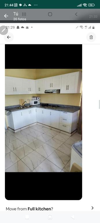 a kitchen with white cabinets and a counter top at July in San Felipe de Puerto Plata