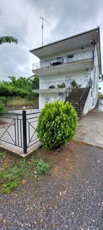 a building with a gate and a bush in front of it at Home garden and big parking in Tripoli