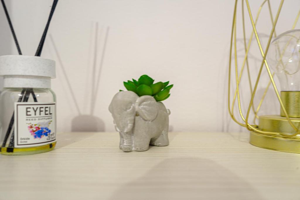 two figurines of an elephant and a plant on a shelf at Hera's Bohemian Home in Arad