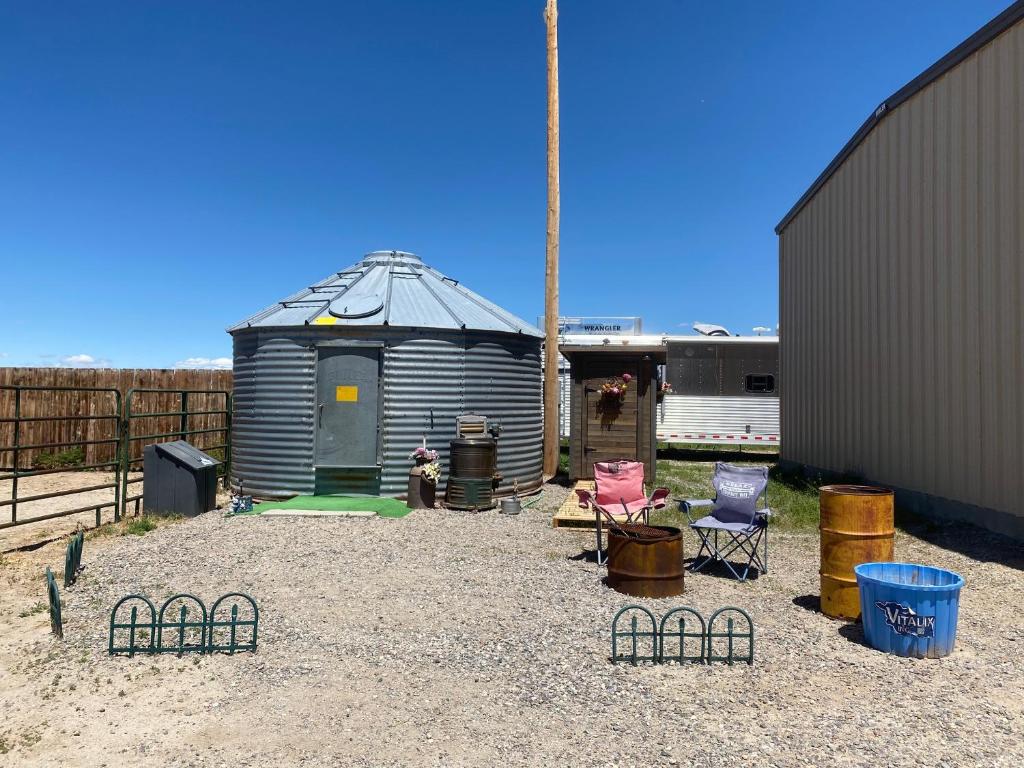 a small shed with a house in a yard at JMA Granary in Riverton