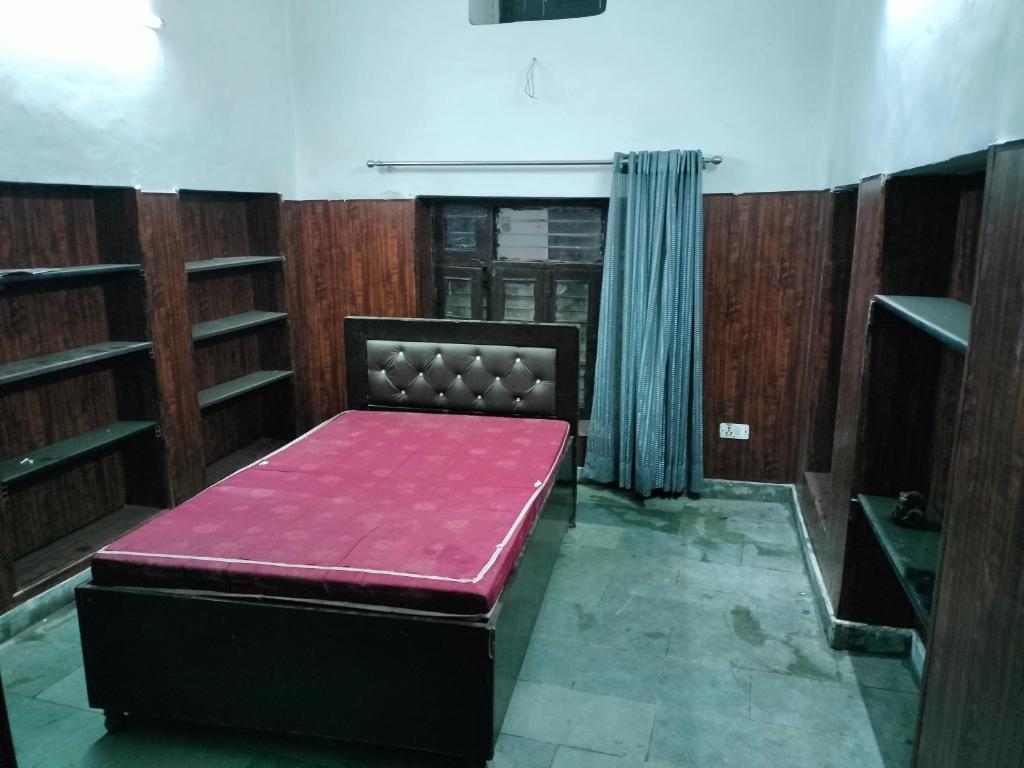 a room with a bed with a pink mattressvisor at WZ-294 G block, Hari nagar,Jail road,near OM sweets or behind fitness factory gym in New Delhi