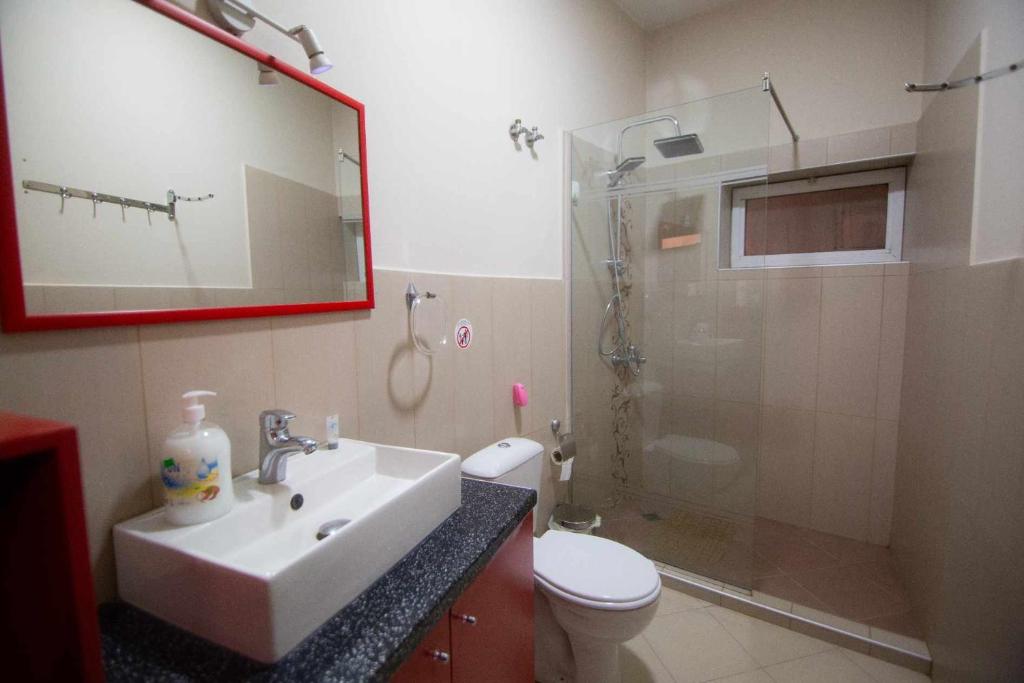 a bathroom with a sink and a shower and a toilet at Villa Elezi 2 in Korçë