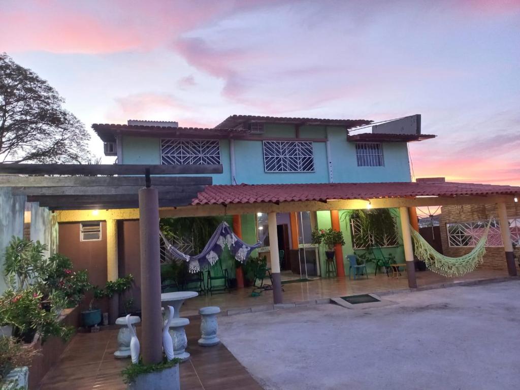 a house with a patio in front of it at Pousada Hotel Araguaia in Aragarças