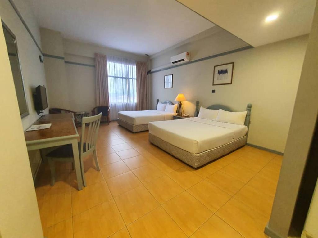 Postel nebo postele na pokoji v ubytování Grace Hotel Lahad Datu