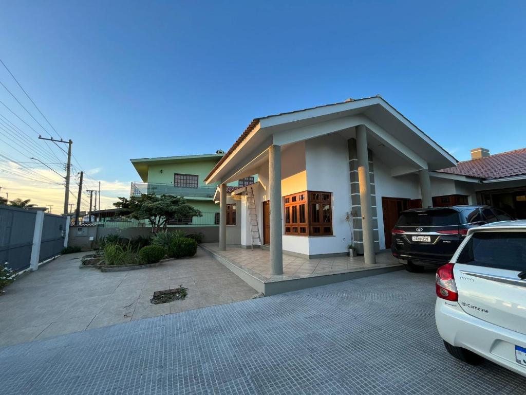 una casa con un coche aparcado delante de ella en Pousada Familiar, en São Gabriel