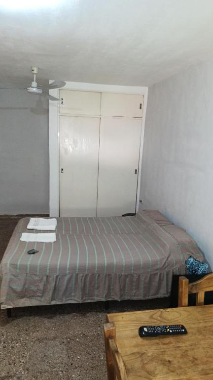Dormitorio pequeño con cama y mesa en Departamento para 2 personas en Bialet Massé