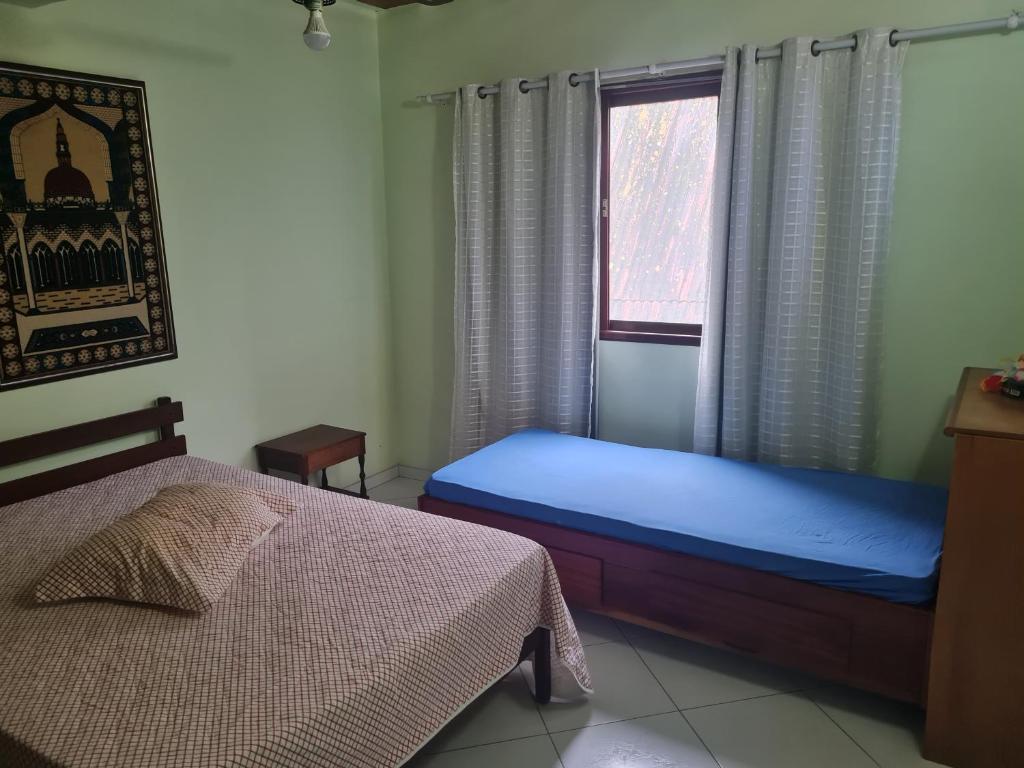 Uma cama ou camas num quarto em Casa de praia