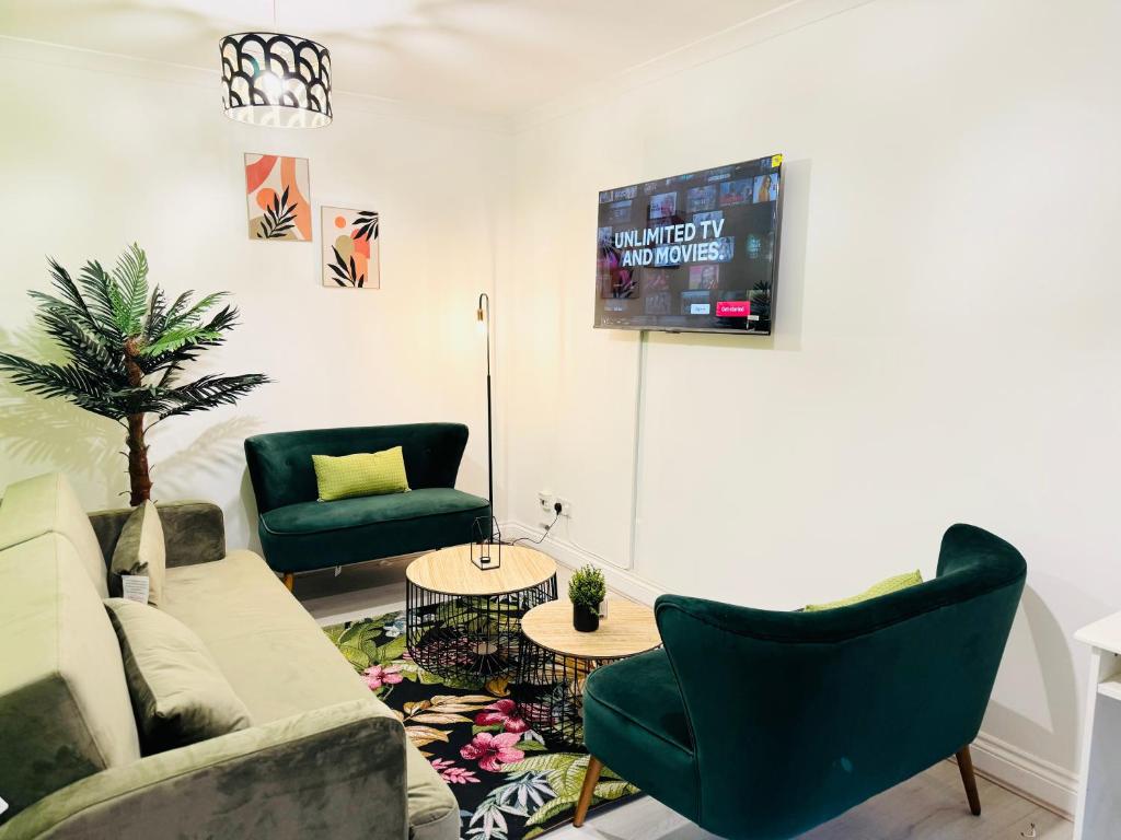 a living room with a couch and chairs and a tv at 5BR House, Free Parking offA12, Contractor, Big Families, Relocation in Redbridge