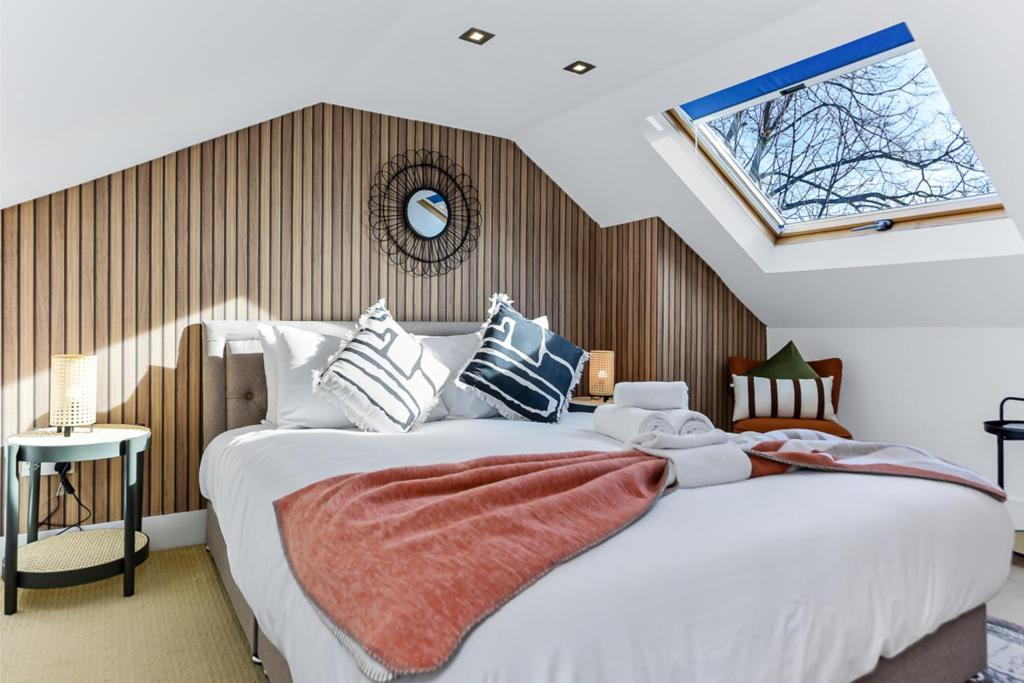 a bedroom with a large bed and a window at Tranquil Terra - Cozy and Soothing Vibe in Hanwell