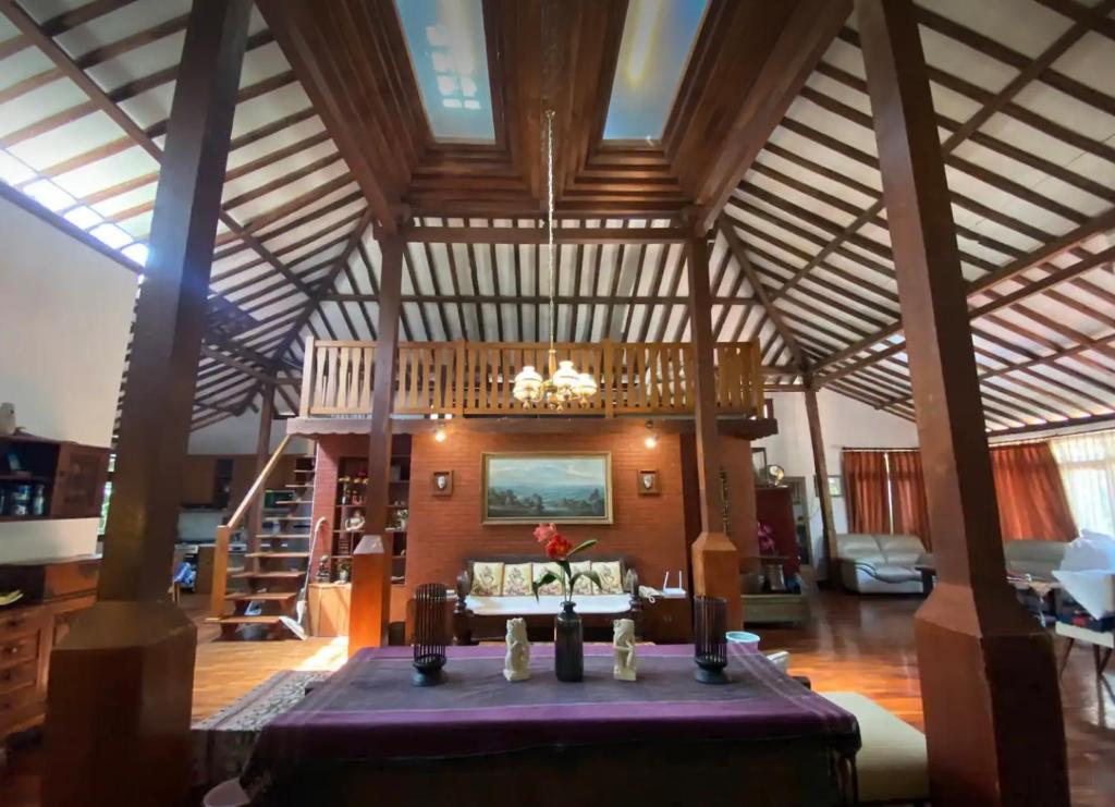 a large living room with a table in the middle at The Joglo Villa in Bandung