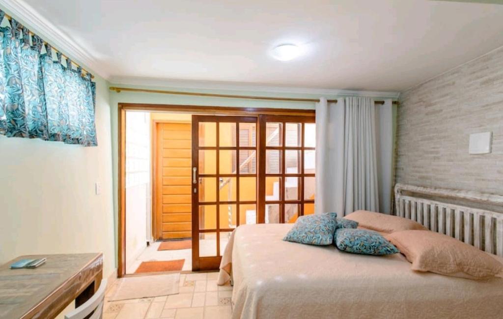 a bedroom with a bed with two pillows on it at Suite Ilhabela in Ilhabela