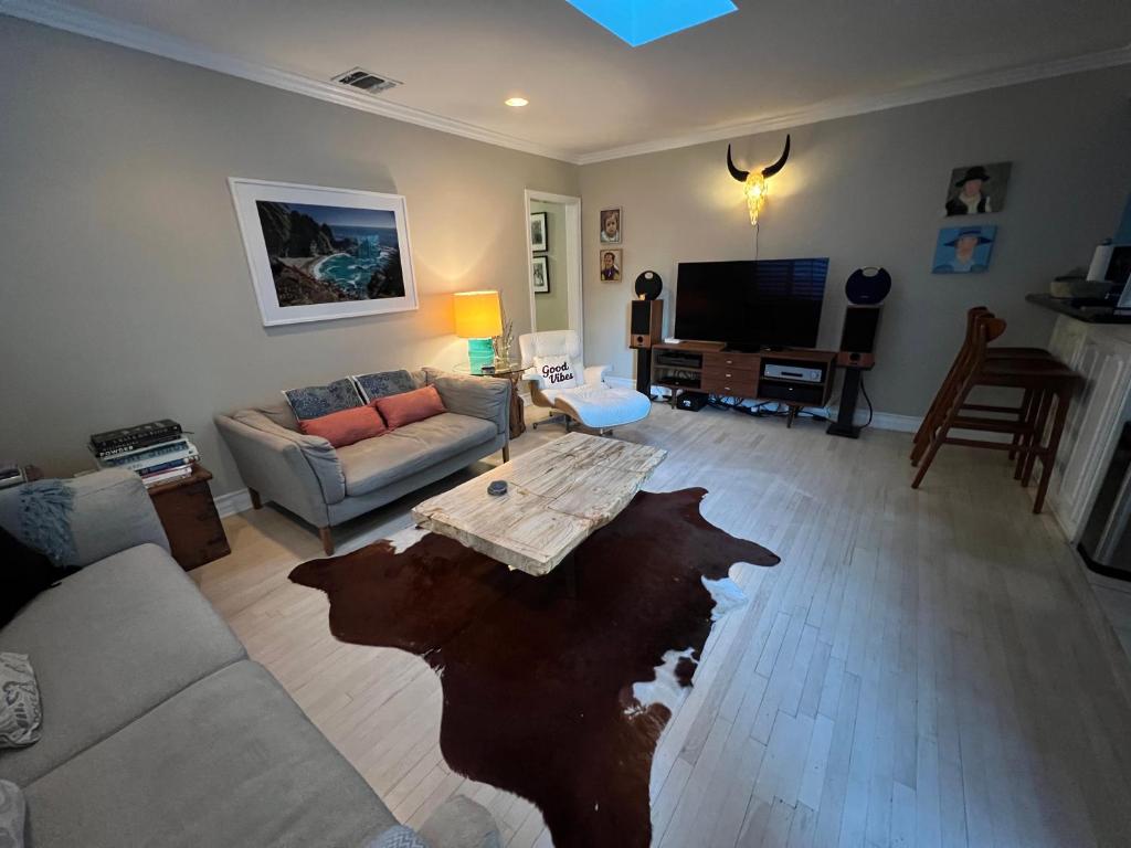 a living room with a couch and a table at Chic Venice Beach Bungalow Steps from the Canals & Beach in Los Angeles