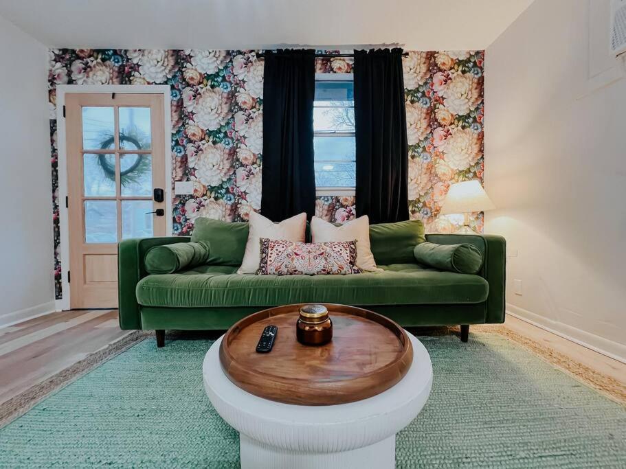 a living room with a green couch and a coffee table at Cozy Urban Escape - East Nashville - Dreami Stays in Nashville