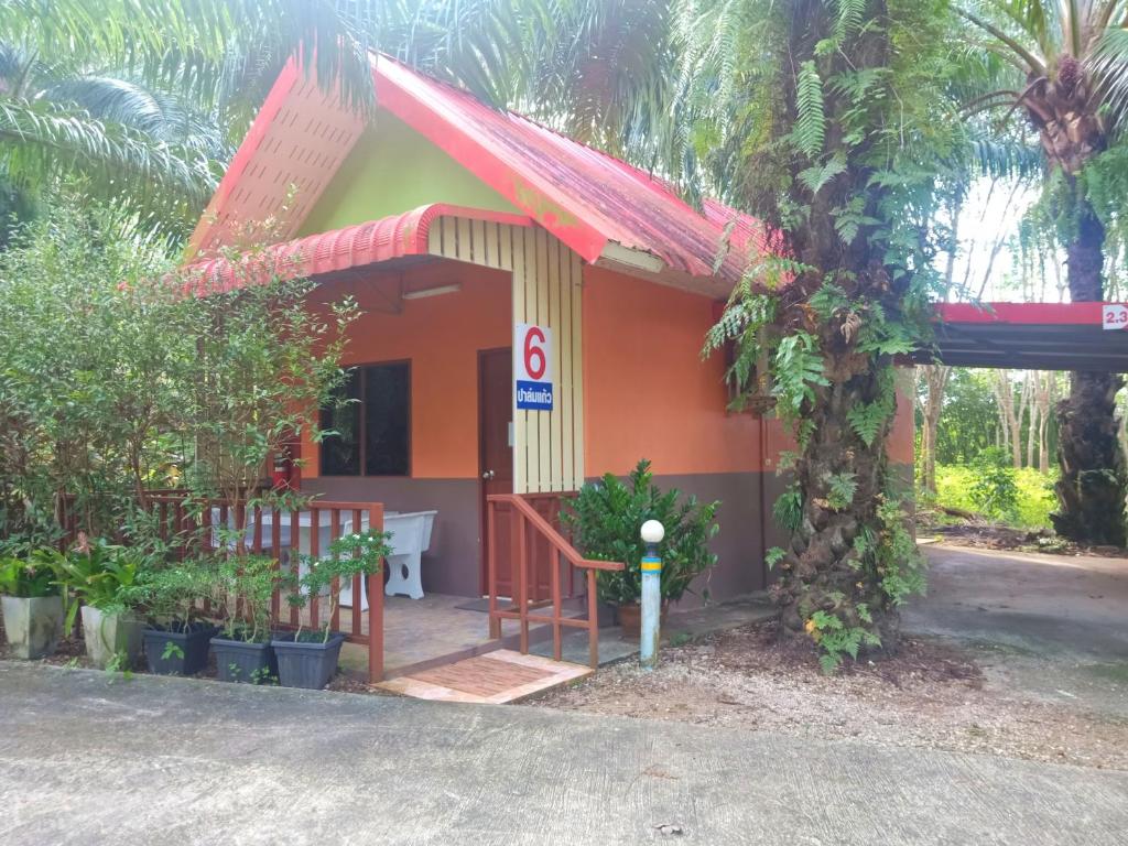 a small house with a red roof at Palm Kaew Resort Krabi in Krabi