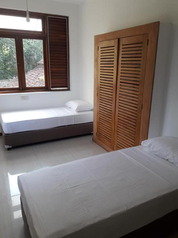 Postel nebo postele na pokoji v ubytování Hostel Residence Bentota