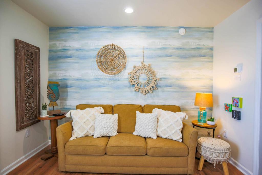 a living room with a couch and a painting on the wall at Shangri-La in Folly Beach