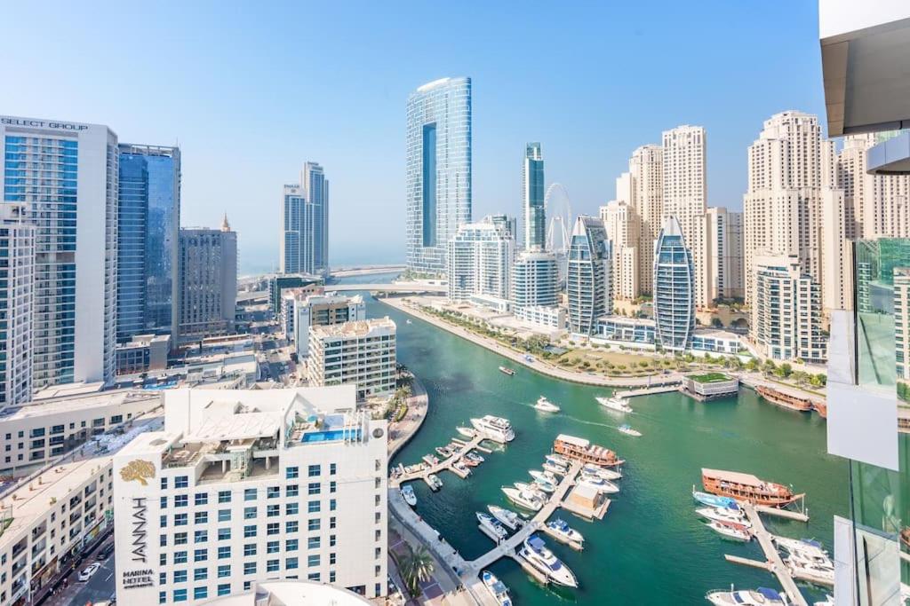 a view of a city with boats in the water at Stayis - 1 BR Marina suite in Dubai