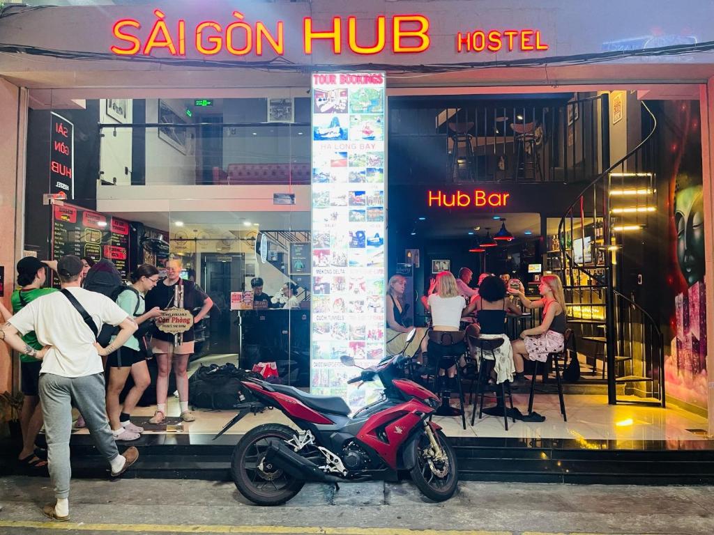 a motorcycle parked in front of a restaurant at Saigon Hub Hostel in Ho Chi Minh City