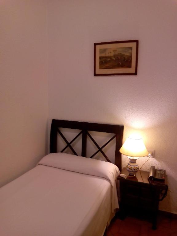 Posteľ alebo postele v izbe v ubytovaní Hotel Simon