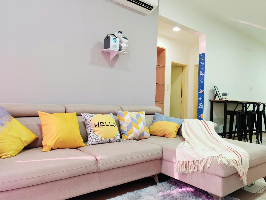 a living room with a couch with colorful pillows at Space Themed KLCC View Condominium @ 6-8 PAX in Kuala Lumpur