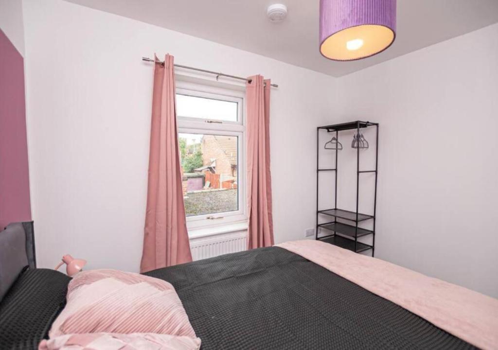a bedroom with a bed and a window at 3 Bedroom Apartment, Fully equipped kitchen - Offer long stays in Lincolnshire