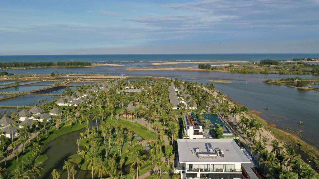 an aerial view of a resort with a river and palm trees at Cocoland River Beach Resort & Spa in Quảng Ngãi