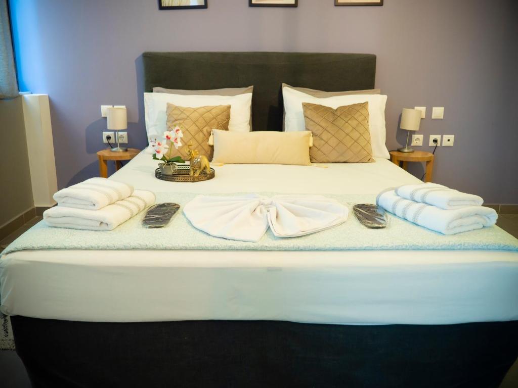 a bed with towels and a bow on it at Modern apartment ATG in Athens