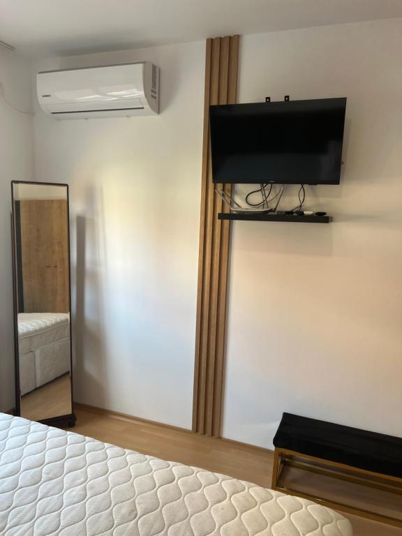 a bedroom with a bed and a flat screen tv at Sea Dreams in Nesebar