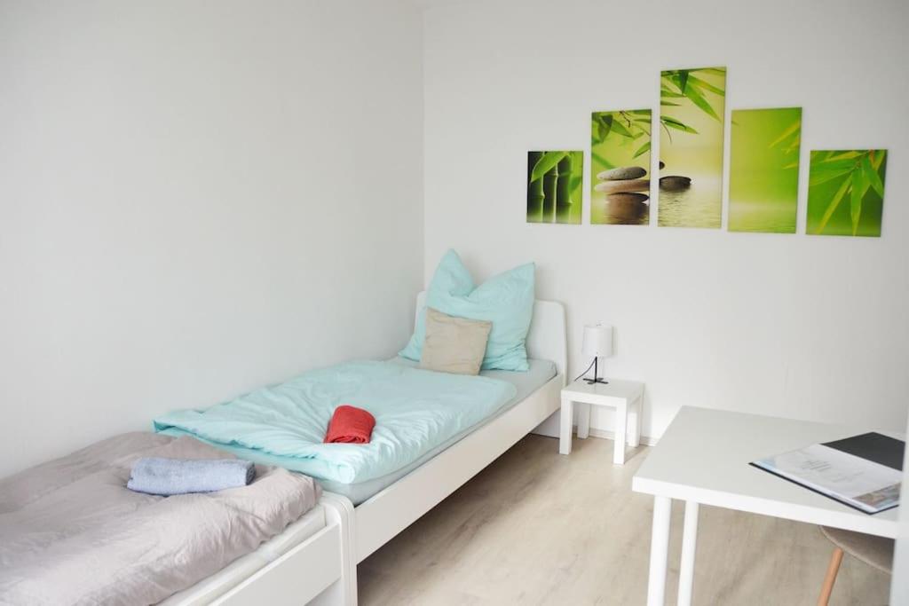 a white couch with pillows and a table in a room at Monteur-Bungalow Dortmund in Dortmund