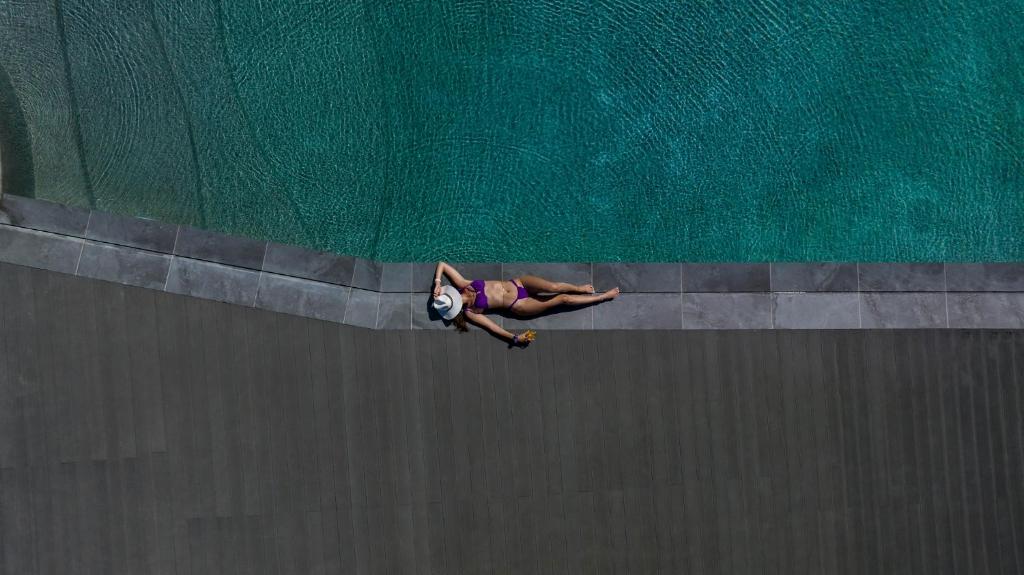 a person on a skateboard in the water at Paros Agnanti Resort & Spa in Parikia