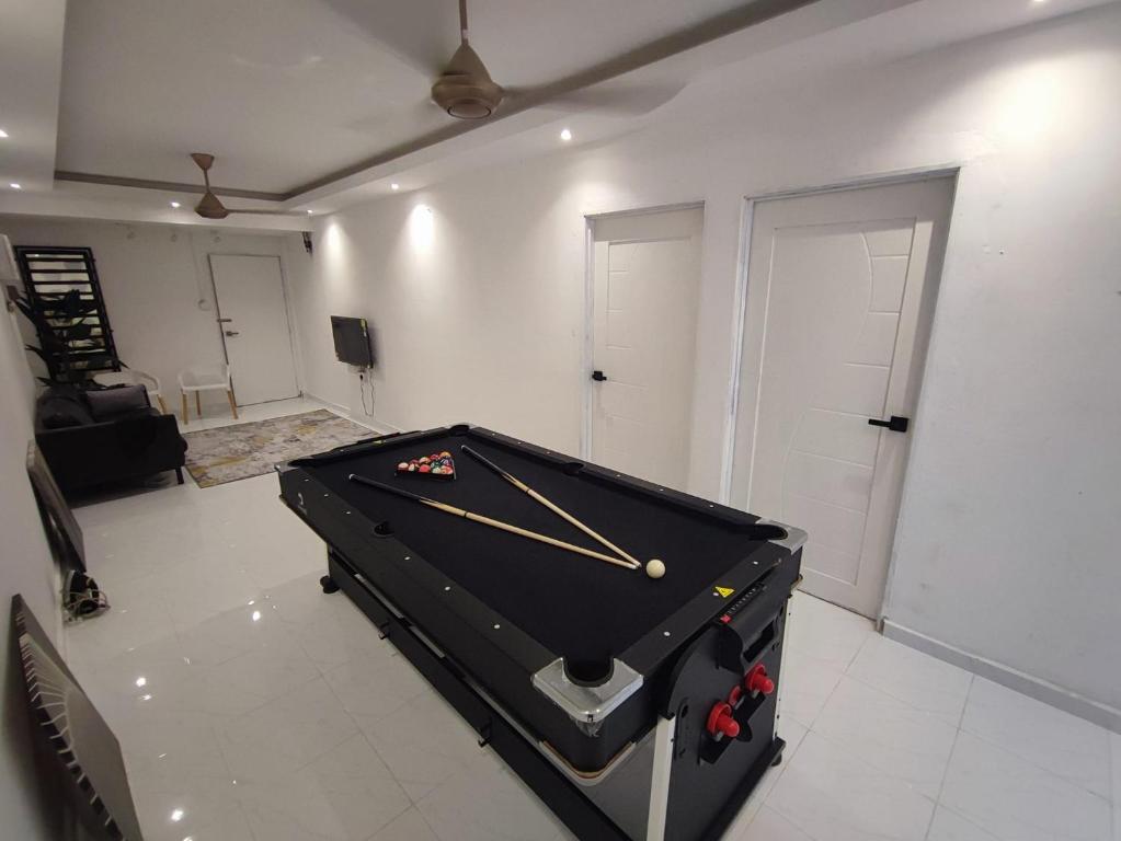 a living room with a pool table in it at Hermoso Homestay Kota Bharu in Kota Bharu