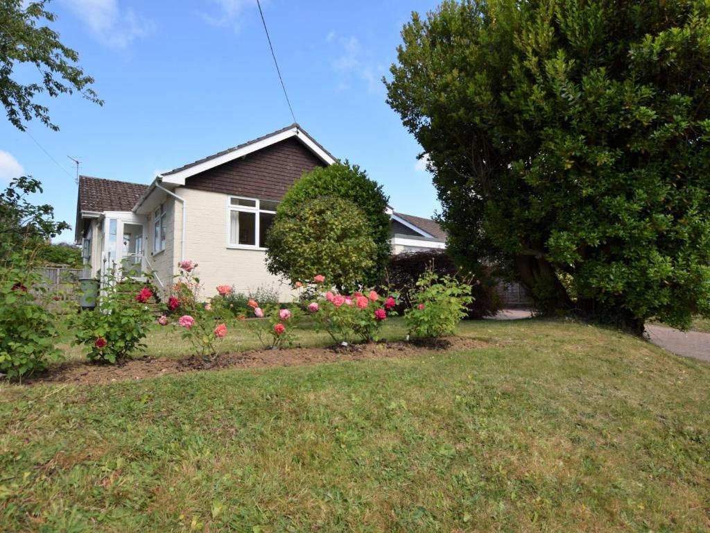 a house with a garden of flowers in the yard at 2 Bed in Brighstone IC132 in Brighstone